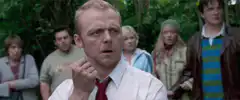 Simon Pegg holding a small object