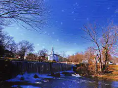 sparkling blue sky over a waterfall and church