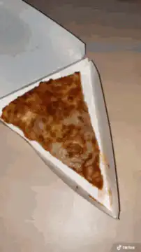Man covered in whipped cream eats pizza