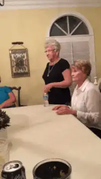 Two women dancing at a table