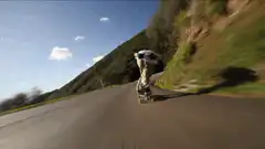 Skateboarder carving downhill