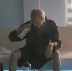 Man chugging a bottle of alcohol