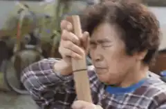 Old man hits wood with Kamen Rider face