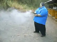 Man in blue shirt shooting gun