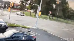 white car drifts through intersection