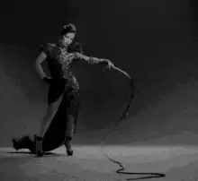 Woman in dress whipping a cat