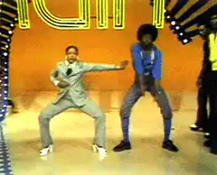 Men in suits dancing on stage