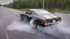 black muscle car doing a burnout
