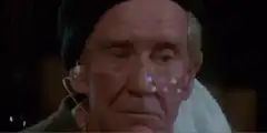 Old man with earpiece and towel