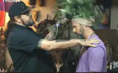 Man smokes another man with sage