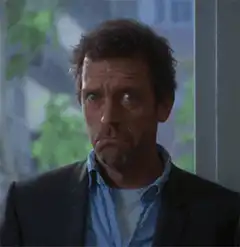 Hugh Laurie as House looking skeptical