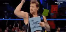 Chris Jericho holding a sign in the ring
