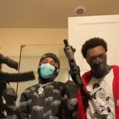 Two men with guns in a house