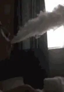 person exhaling large cloud of vapor