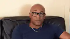 Man turns off TV with remote