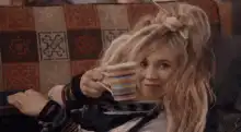 Phoebe Buffay holding a mug