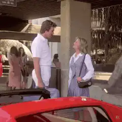 Tom Selleck smirks at woman