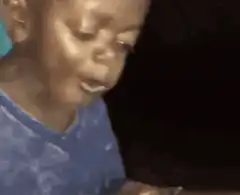 Young boy eating and rolling his eyes