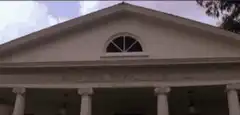Tony Montana walks out of the mansion