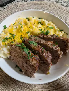 sliced meatloaf with mashed potatoes