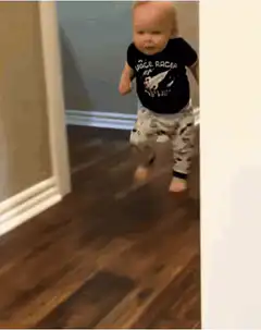 Toddler running in space shirt