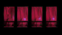 Four red curtained windows with silhouettes