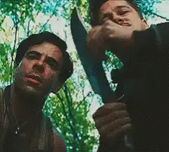 Two men in the woods with a machete