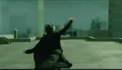 Neo dodging bullets on rooftop