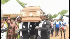 Dancing pallbearers carrying coffin