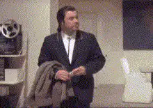 John Travolta holding a coat and gesturing