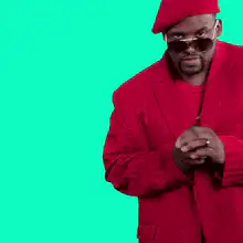 CeeLo Green dancing in red outfit