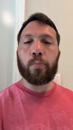 Man with beard looking at camera