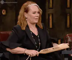 Lesley Manville swings wooden sword