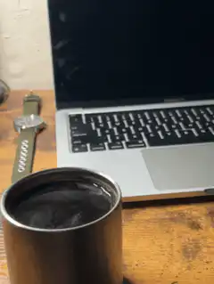 Coffee cup on desk with laptop