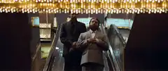 Two men on an escalator