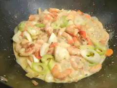 Shrimp and vegetables cooking in a wok