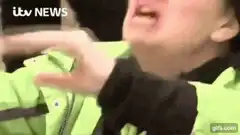 Man in green jacket screaming
