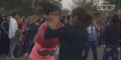 Two women fighting in a crowd