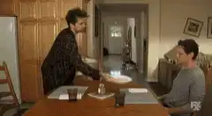 Man throws plate at another man