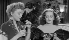 Two women drinking cocktails in black and white