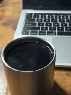 Coffee rippling on laptop desk