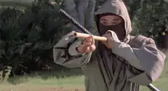 Ninja throws sword, man shoots it with revolver