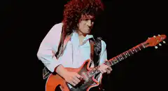 Brian May playing guitar on stage