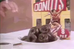 Man smokes while eating chocolate donuts
