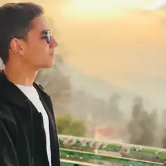 Man in sunglasses looking at sunset