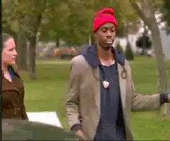 Man smoking in park with woman