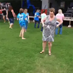woman dancing on grass at outdoor event