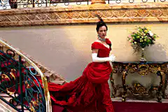 Woman in red dress posing on stairs