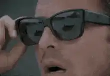 Man holding two pairs of sunglasses