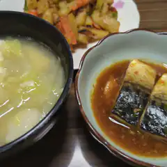 Japanese meal with miso soup, grilled fish, and stir-fried vegetables